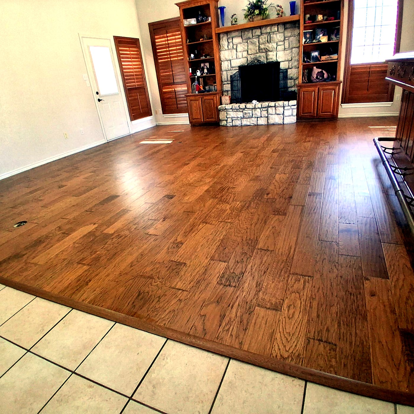 FloorFlash walnut hardwood floor installed in a DFW kitchen with white cabinetry